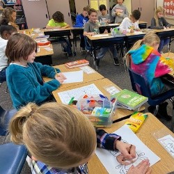 Students coloring with the principals